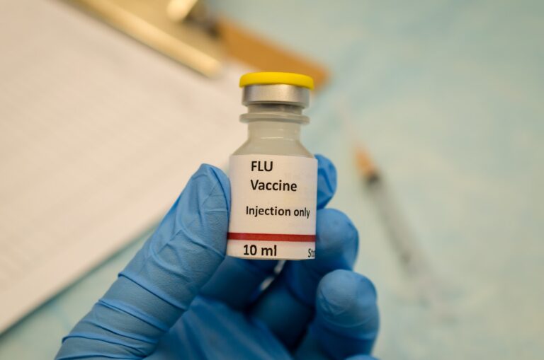 Flu control by flu vaccine holding in hand