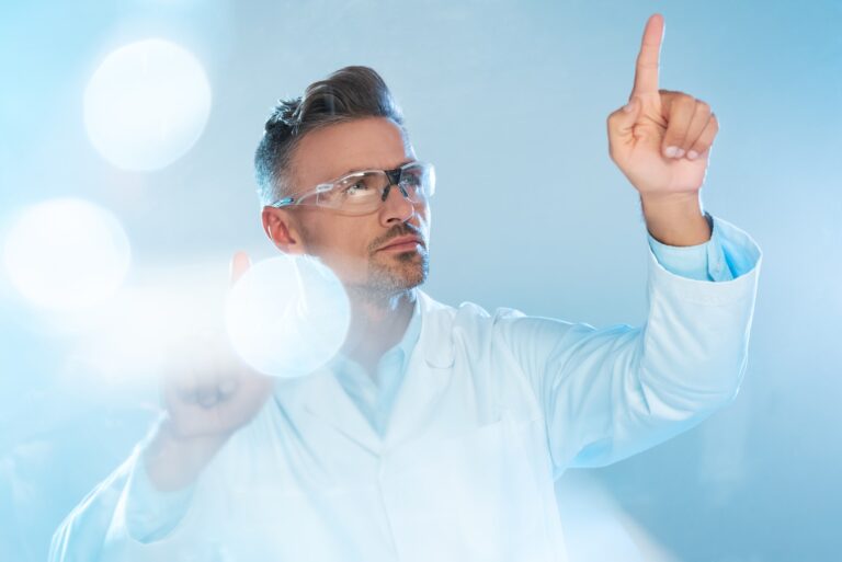 handsome technologist in protective glasses and white coat touching something isolated on white,